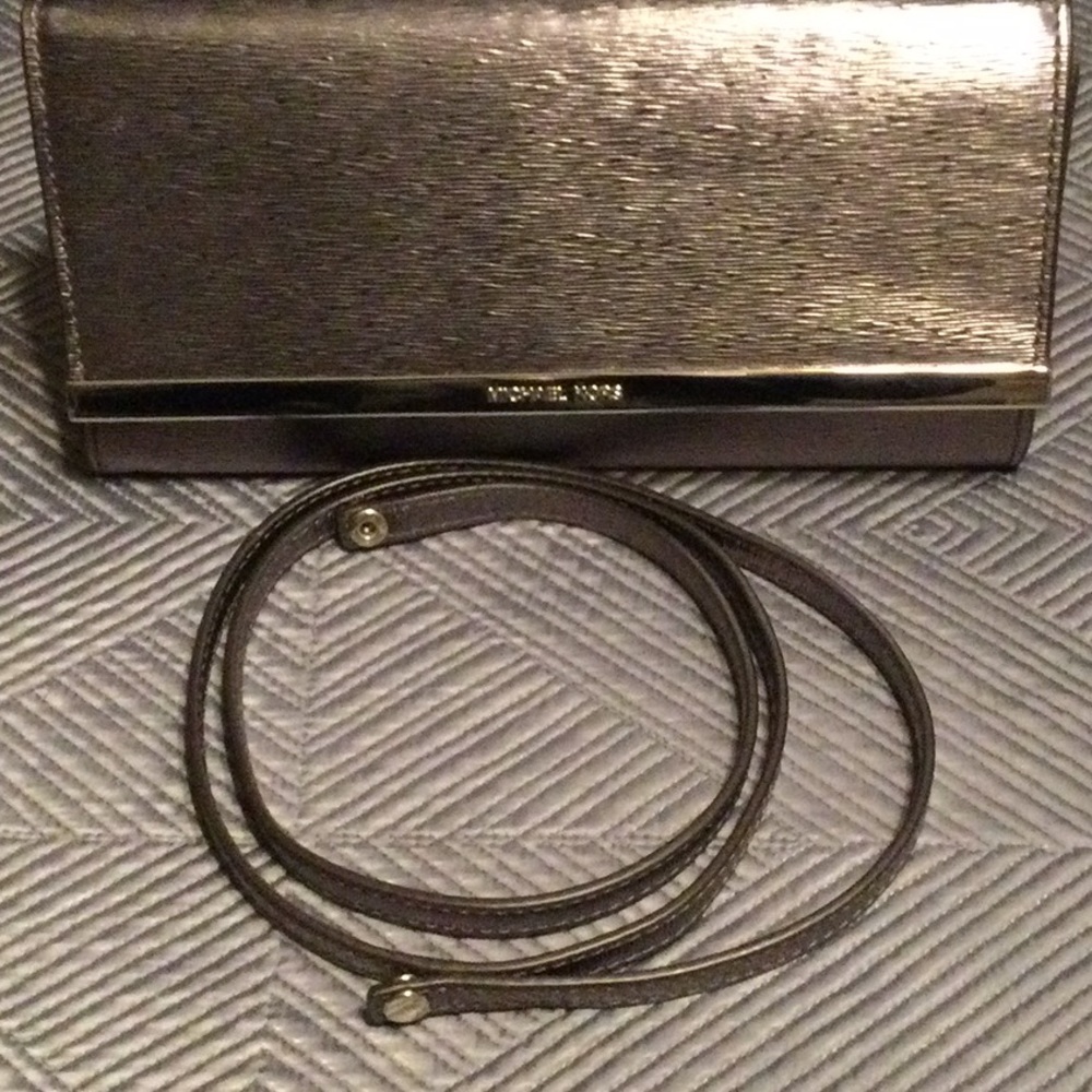 Michael Kors silver tone shoulder handbag with a detachable 47” strap.